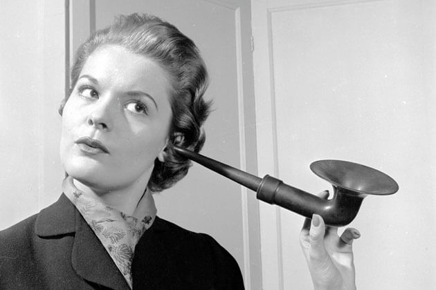 Woman using ear trumpet Assistive Listening Technology